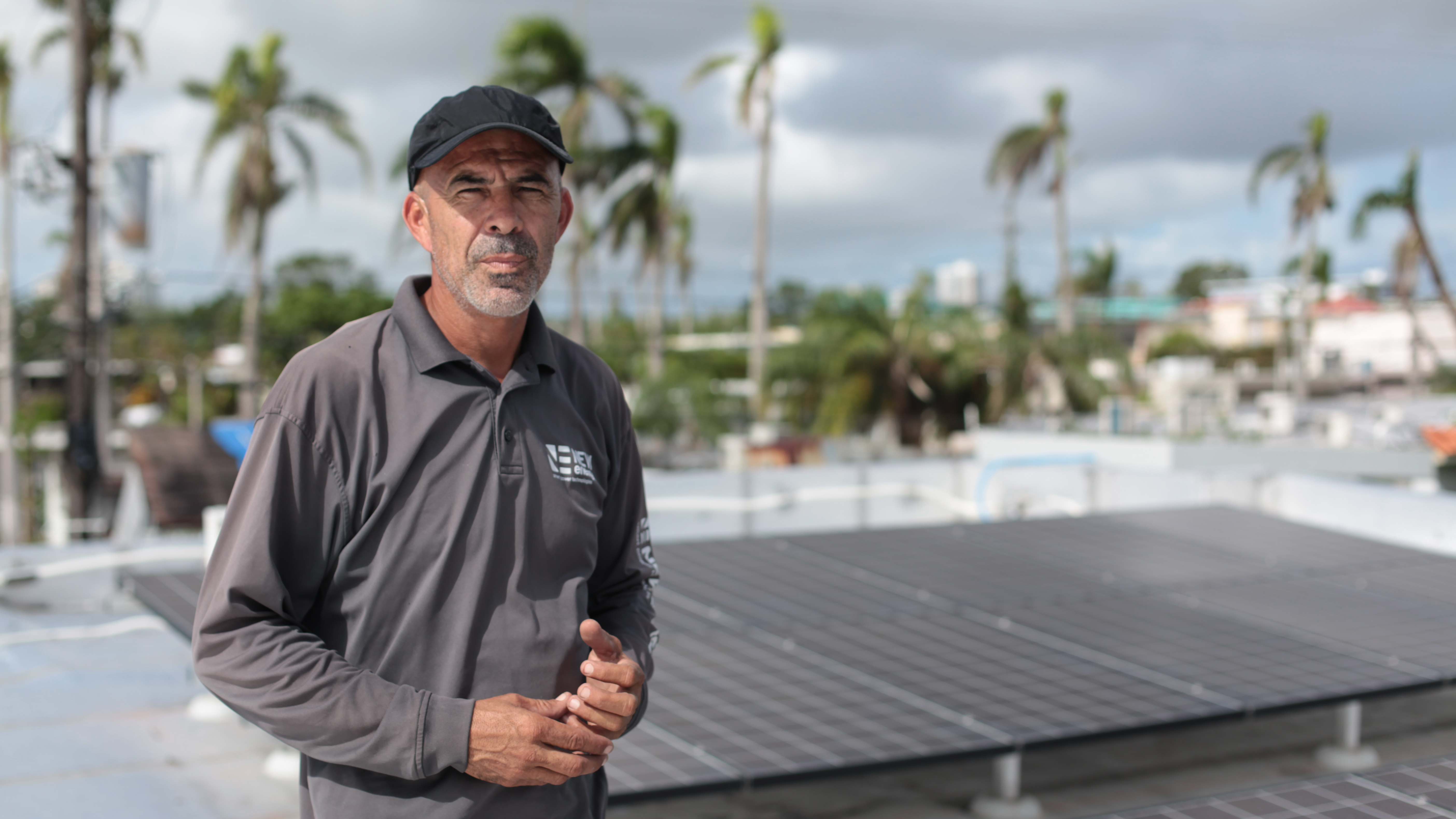 PR Rooftop Technician Alexis Portalatin stands next to rooftop solar panels he is connecting to a new Tesla battery storage system the San Juan suburb of Guaynabo. The storage system will allow the panels to operate separately from the power grid and supply electric
